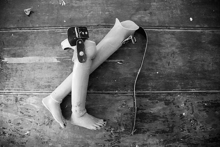 Two Prosthetic Legs on Wooden Surface