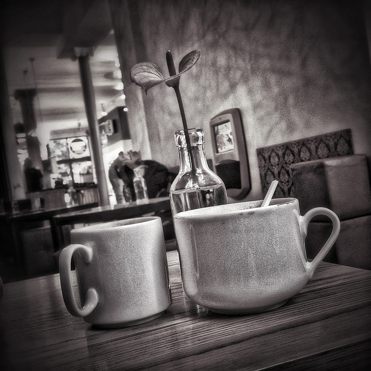 grayscale photo of two ceramic mugs