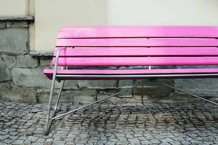 Wide angle shot of a vibrantly coloured pink bench in an urban setting, image captured with a Canon DSLR
