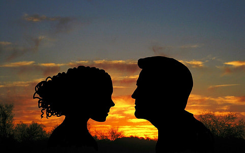 silhouette photo of man and woman during sunset
