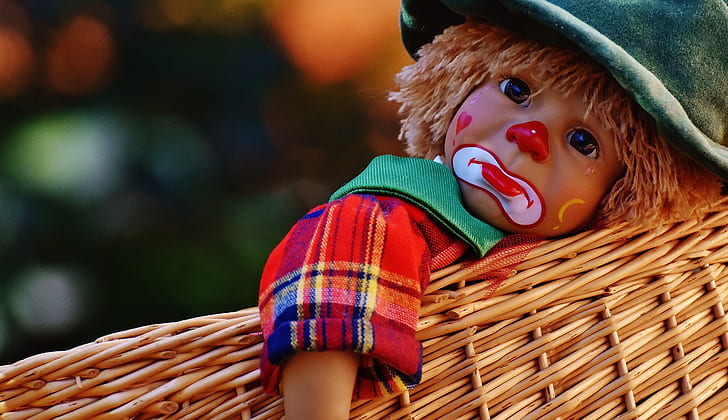 clown doll on brown wicker basket