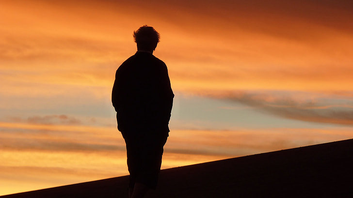 silhouette photography of man during golden hour