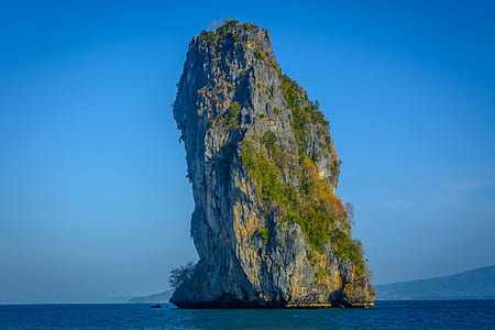 photo of green mountain island in body of water