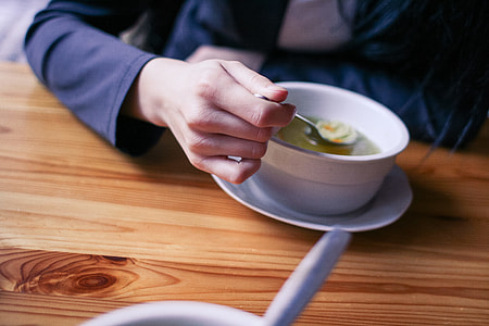 Woman Eating a Soup