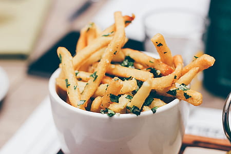 shallow focus photography of fries filled white ceramic bowl