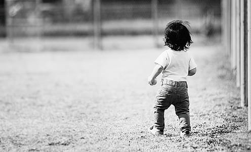 child walking near fence