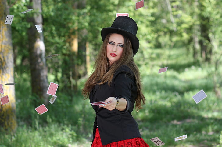 woman in black blazer doing card magic