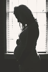 pregnant woman near window