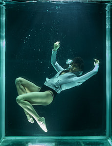 underwater photography of man wearing gray jacket