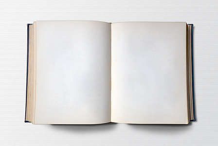 white opened blank book on top of white surface