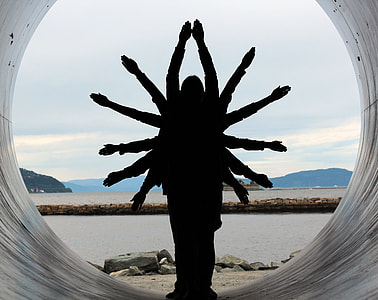 silhouette photo of six person doing arm gesture