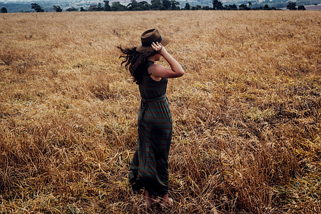 Woman wearing a hat standing in a wheat field