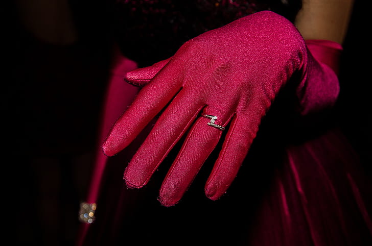 person wearing red gloves and silver-colored ring