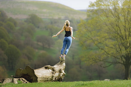 woman standing on brown wood at daytime