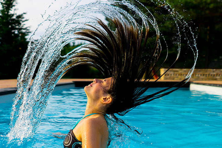 Royalty-Free photo: Woman taking bath on swimming pool at daytime ...