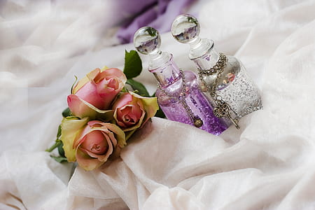 pink roses flowers and two clear glass bottles