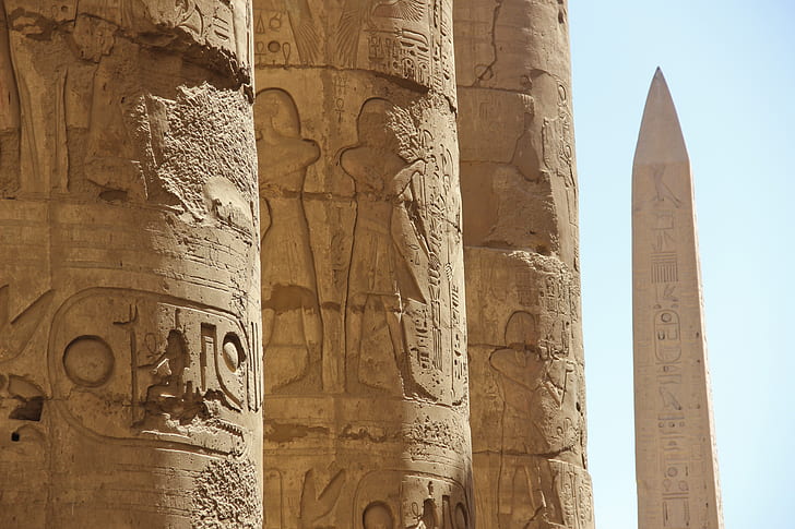 photo of brown pillars with hieroglyphs