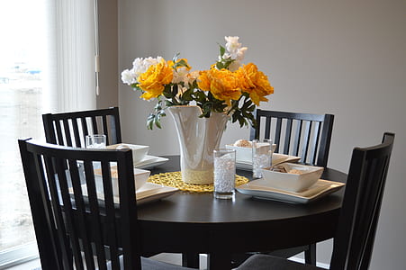 photo of yellow and white flowers on top of table