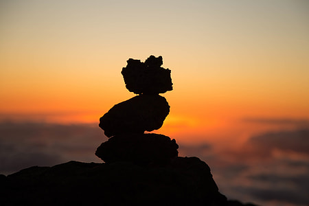 Silhouette of a pile of rocks at sunset