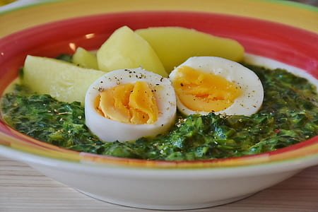 photo of soup dish with egg and papaya in red and yellow ceramic bowl