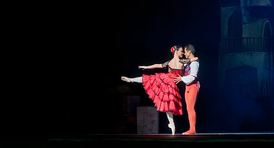 man and woman dancing on stage