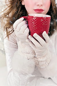 woman holding red mug