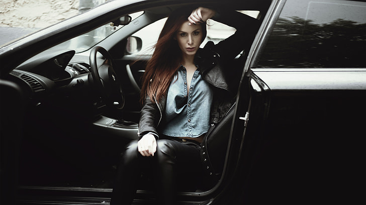 woman in black jacket sitting inside car