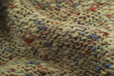 macro photography of brown, blue, and red textile