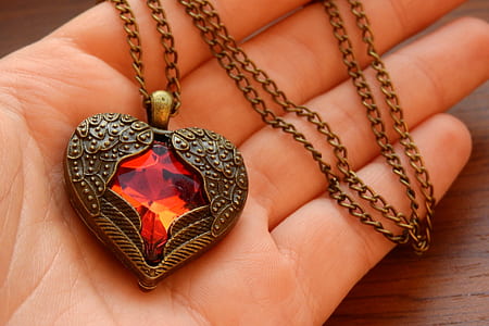 brass-colored chain necklace with heart pendant