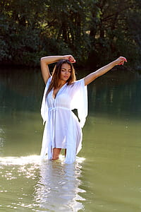 woman wearing white top submerged in body of water