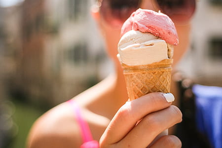 person holding coned ice cream