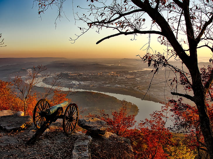 photo of black cannon on top of mountain facing city