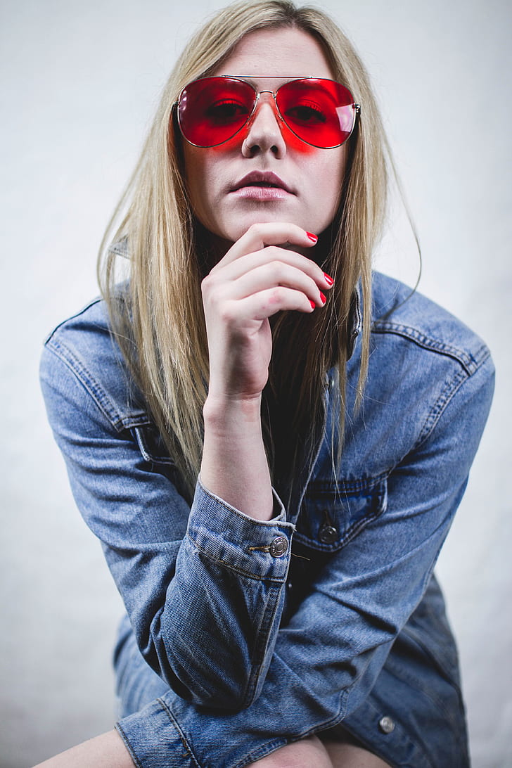 woman in red lens sunglasses wearing blue chambray jacket