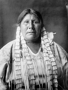 grayscale photo of woman wearing Native American attire