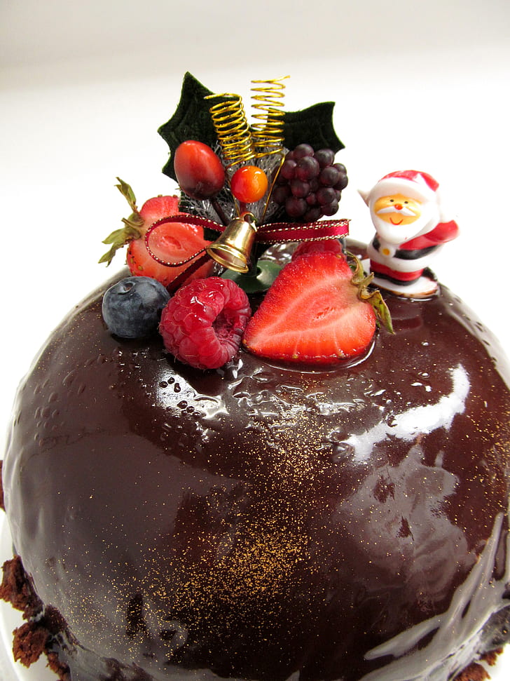 round chocolate coated cake with berry topping