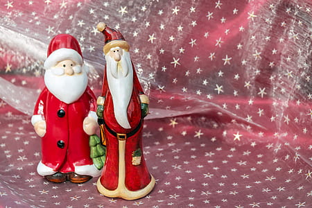 close up photograph of two Santa Claus ceramic figurines