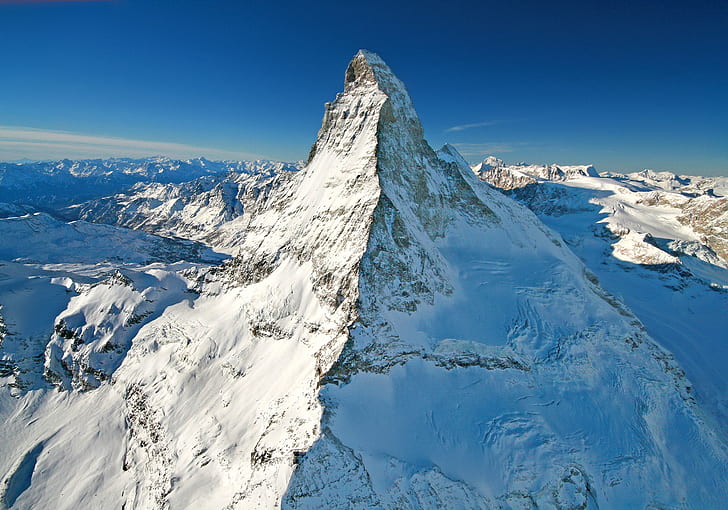 mountain covered with white snow under blue sky aerial photography