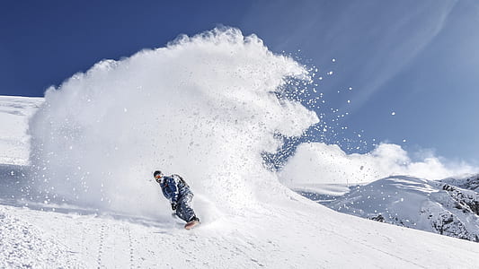 person on snow mountain white snowboarding