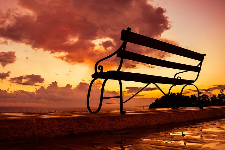 silhouette photo of bench during golden hour