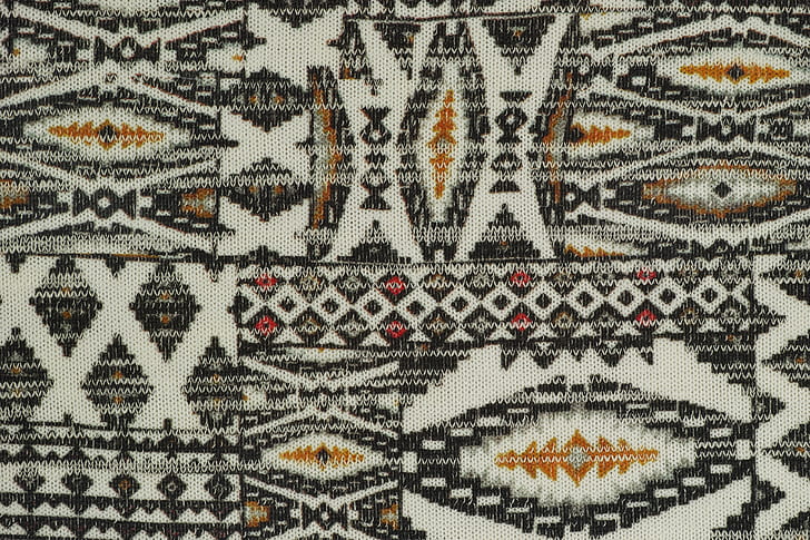 white, gray, and yellow aztec textile