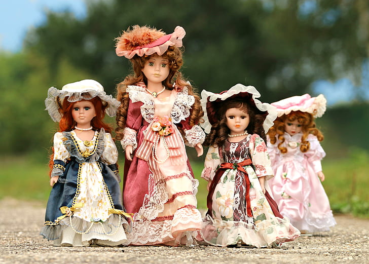 four female dolls in pink and blue dresses