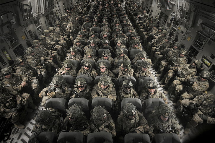 photo of soldiers riding in cargo plane