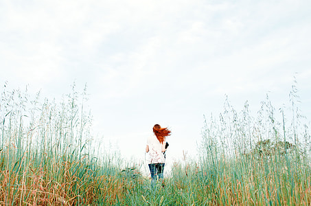 woman standing on green grass field during daytime
