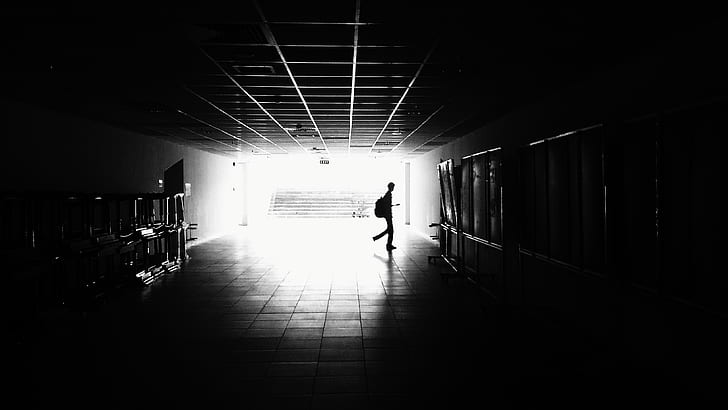 Silhouette of Man Walking on Hall