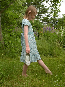 girl walking on lawn during day time