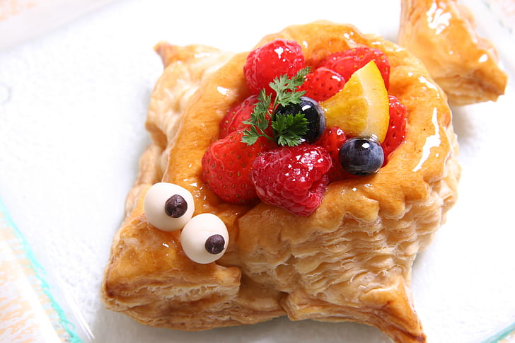 fish-shaped pie with raspberries and blueberries topping