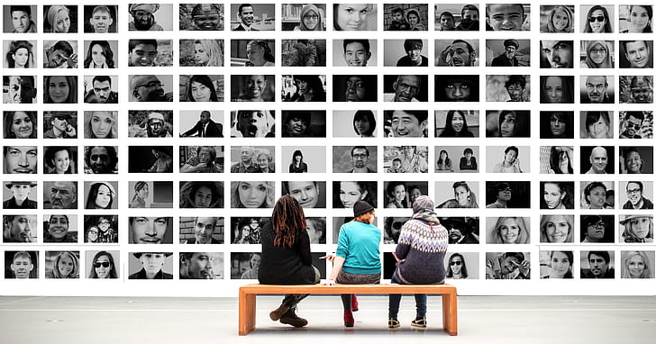 three people sitting on bench in front of collage photos
