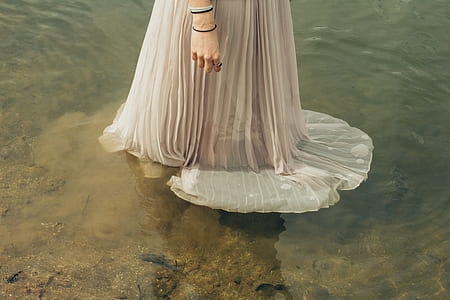 woman in grey dress on top of water