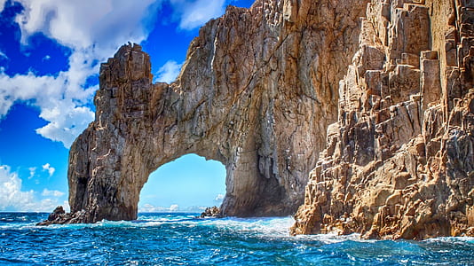 arch formation on cliff near the sea