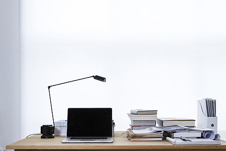 black and gray laptop computer beside of black desk lamp